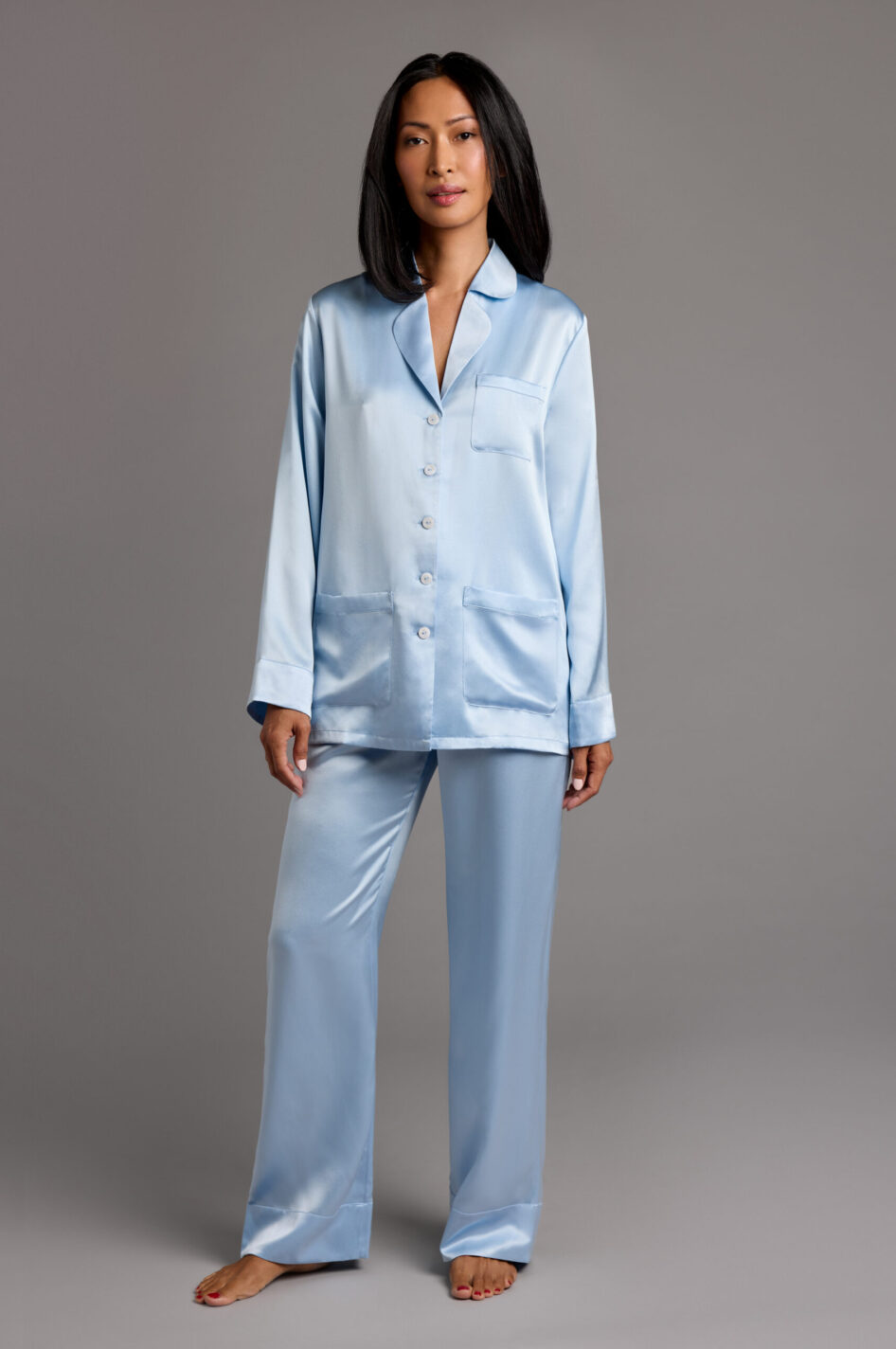 Model wearing light blue silk pyjamas made from 100% Mulberry silk