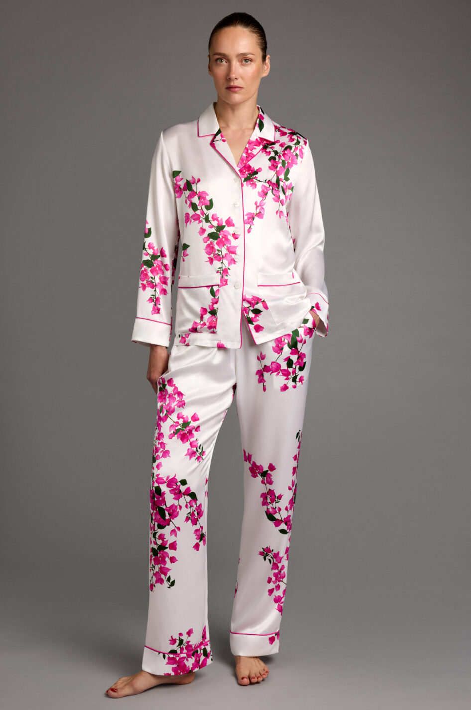 Front view of model wearing floral silk pyjamas with bougainvillea print and matching sleep mask